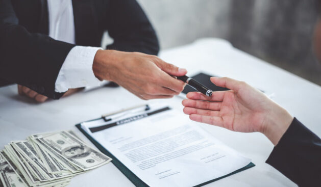 Businessman giving pen to businesswoman for signing contract banking money loaning